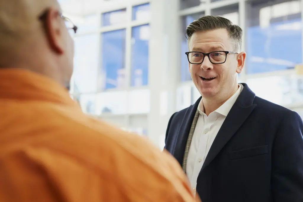 Two men talking in an office