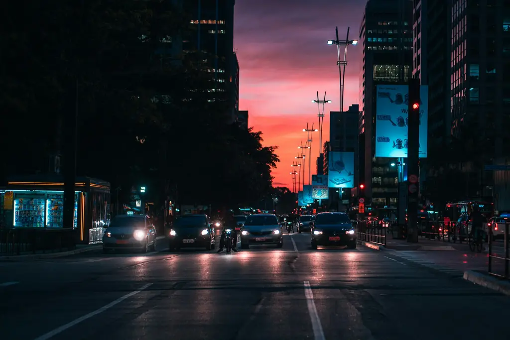 A city street at dusk with car headlights