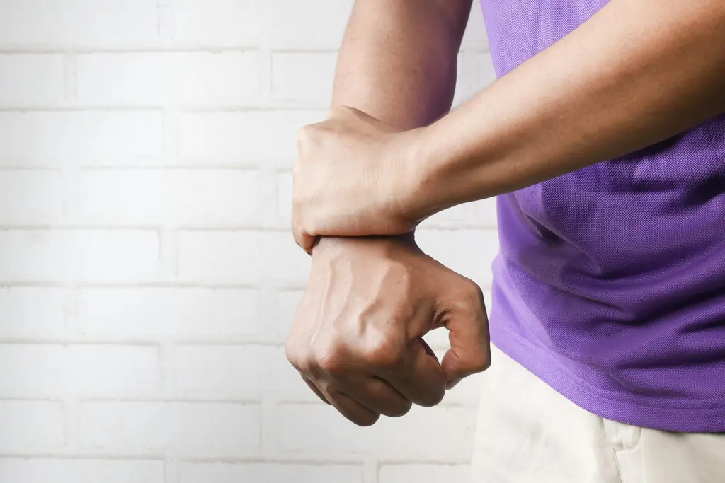 A man gripping his forearm