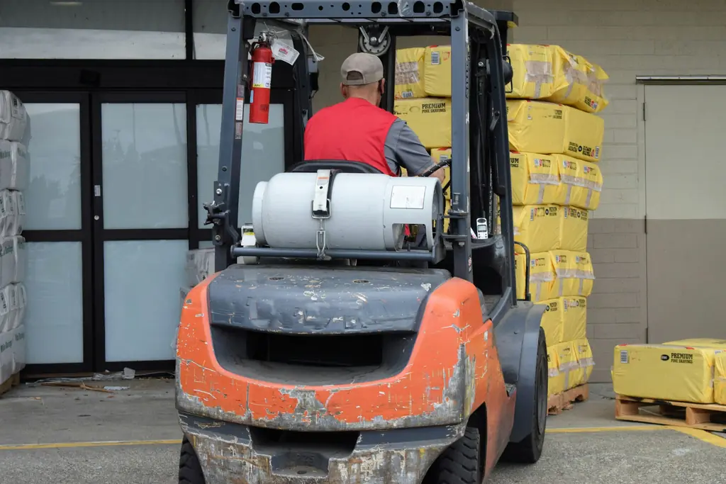 A forklift operator moving stock in a warehouse