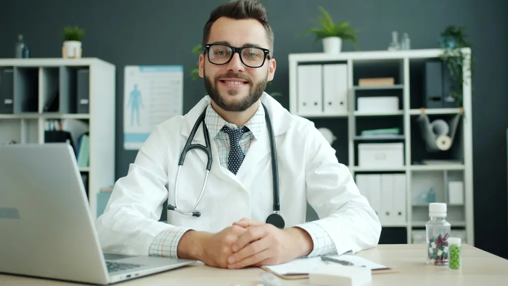 A doctor with a stethoscope sitting at a desk