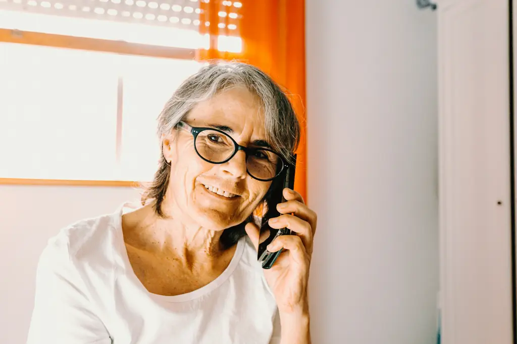 A woman smiling while talking on the phone
