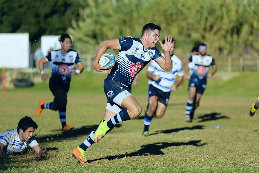 Players running with the ball during a rugby match