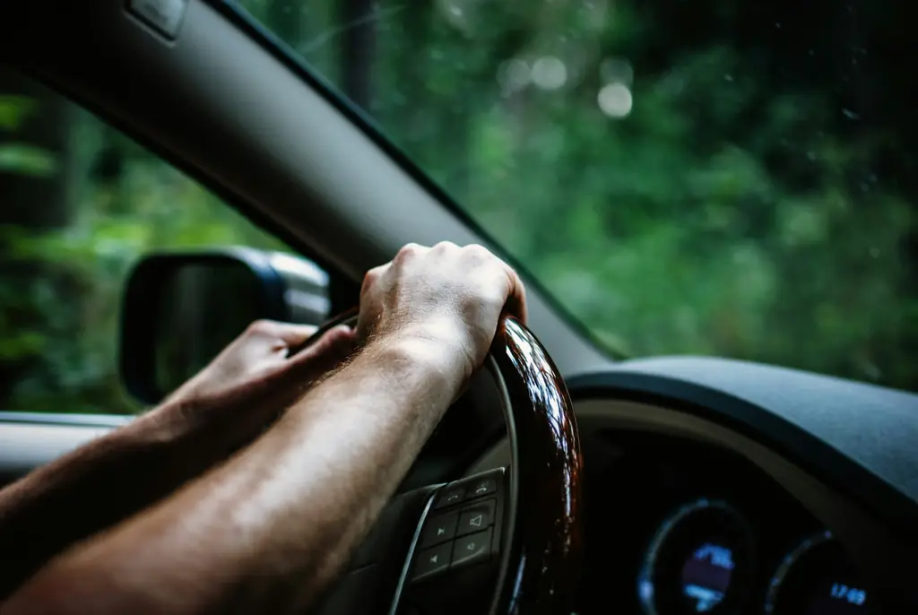 Hands on the steering wheel of a car