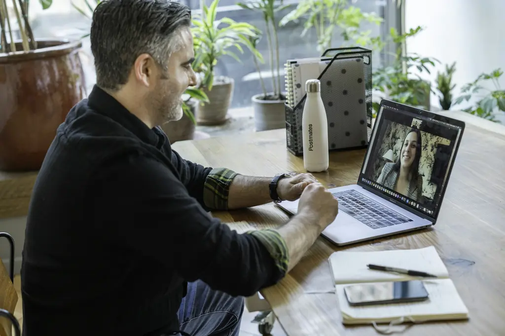 A man on a video call at a laptop