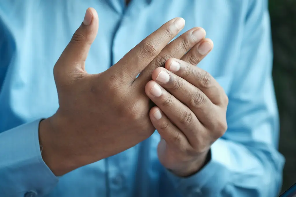 Hands pressing at the base of the thumb